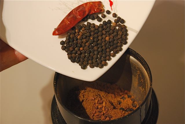Putting spices in a coffee grinder