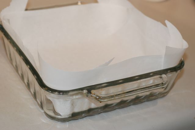 Glass baking dish lined with parchment paper