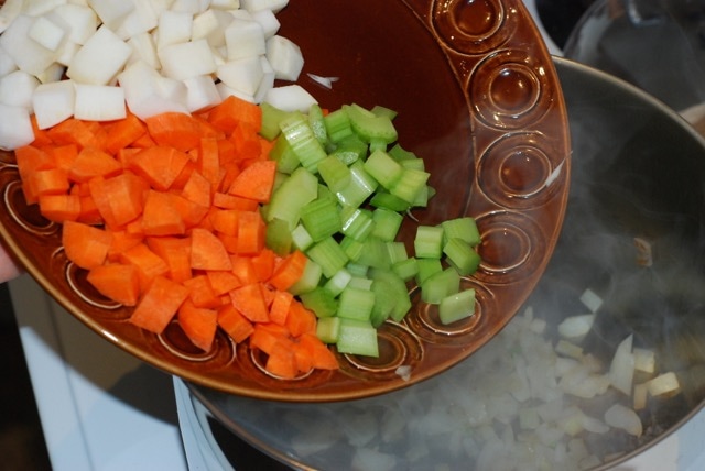 Adding the celery, carrot, and turnip to the cooked onion