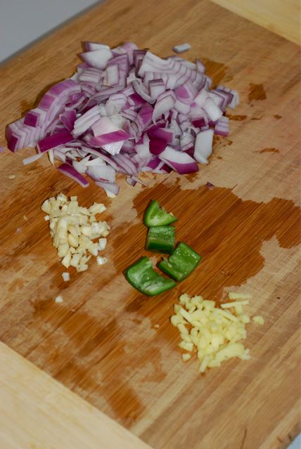 Diced red onion, minced garlic, minced ginger, and chopped and seeded serrano chili