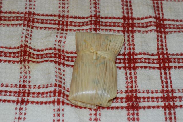 Securely wrap the parcel with strip of corn husk and tie