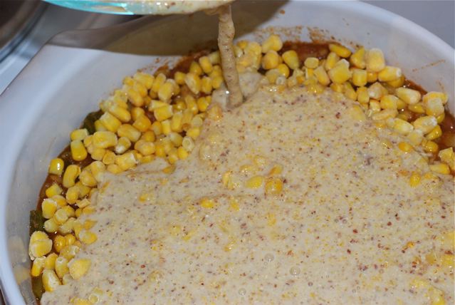 Pouring the batter over the chili and frozen corn