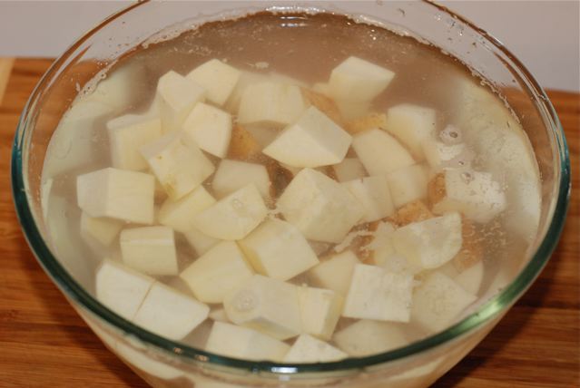 Cubed potatoes and sweet potatoes soaking in cold water