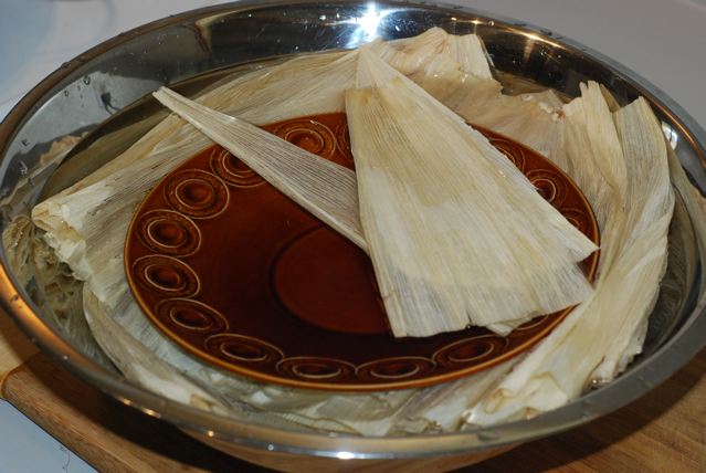 Dried corn husks submerged in water