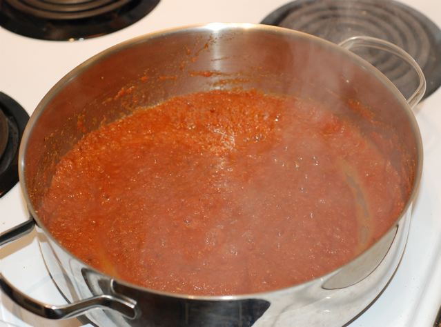 Add the tomatoe puree to the toasted spices in the pan