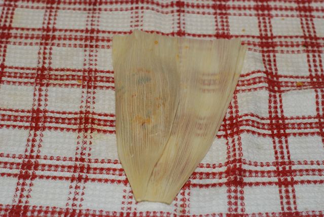 Fold one side of the corn husk over the dough