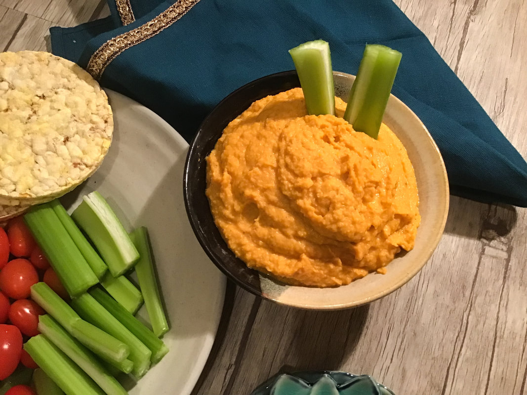 Photo of this beautiful orange hummus served with cut veggies and corn thins--Carrot hummus / Gluten-Free, Oil-Free, Vegan--beansriceeverythingnIce.weebly.com