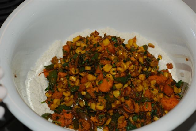 Cooled vegetables added to the corn masa in the bowl