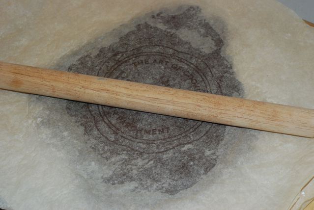 Rolling out the dough between two sheets of parchment paper