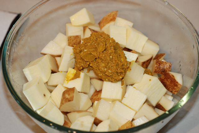 Mustard paste on top of the drained potatoes