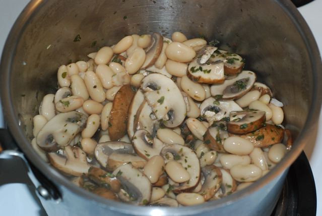 Cooked mushrooms with herbs and white beans