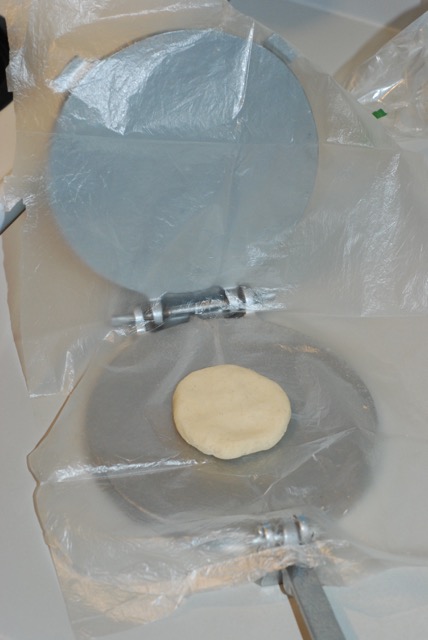 About to form a tortilla with a tortilla press
