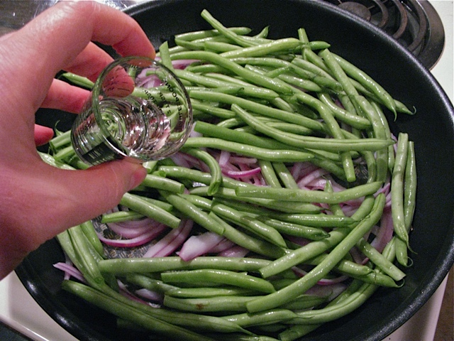 Add the green beans and a splash of water