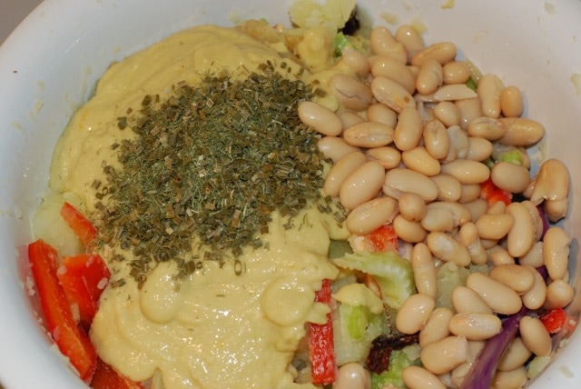 Add the dressing, herbs and remaining beans to the mixing bowl