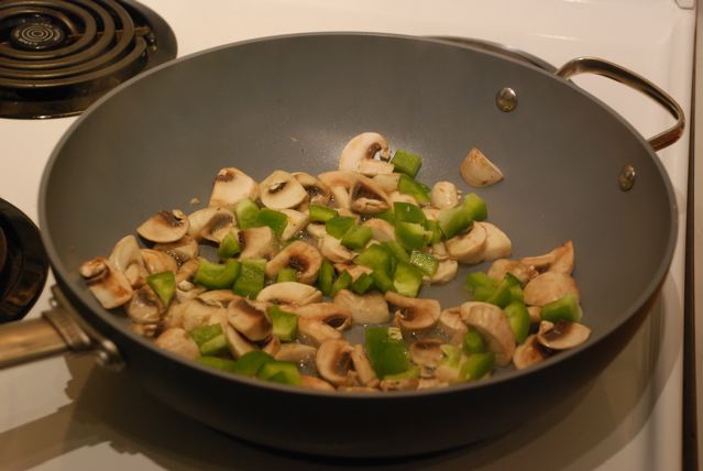 Saute mushrooms and green peppers