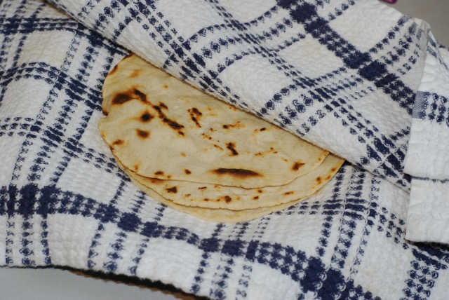 Place finished tortillas between the layers of a folded towel.