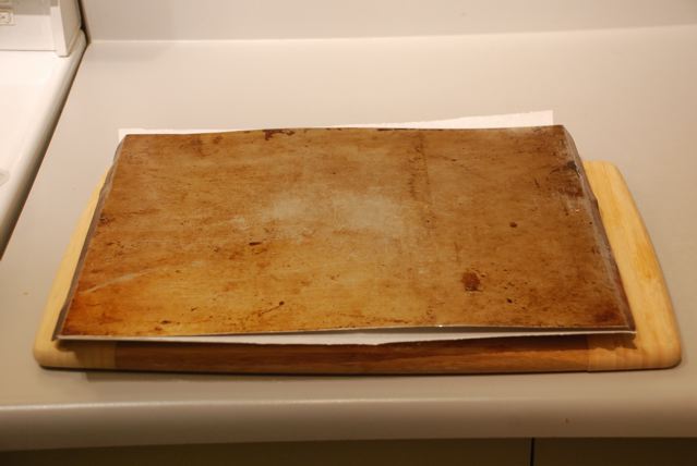Put a parchment-lined cookie sheet over the polenta round on the cutting board and flip again