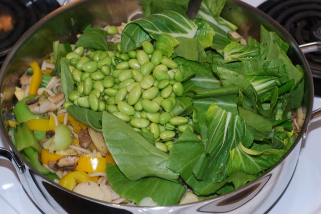 Add the edamame and the bok choi leaves