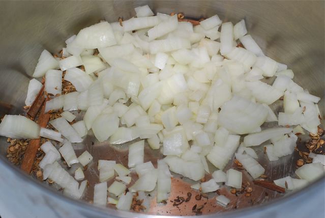 Diced onions added to the pan with the toasted seeds