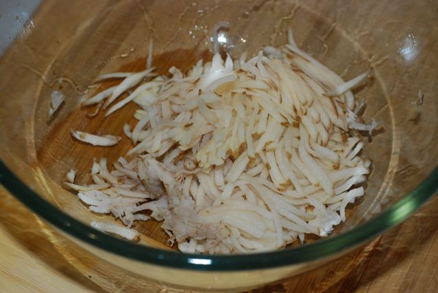 Squeezed shredded potatoes in a bowl