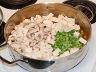 Mushrooms, peas and tofu added to the pan