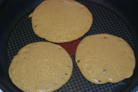 Uncooked pancakes in the pan.
