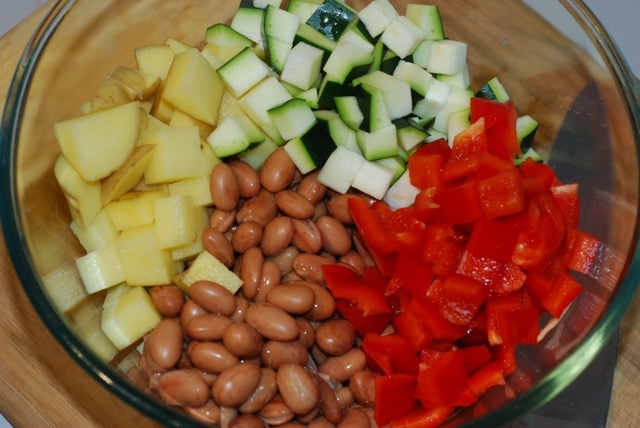 Vegetables and beans in a large mixing bowl