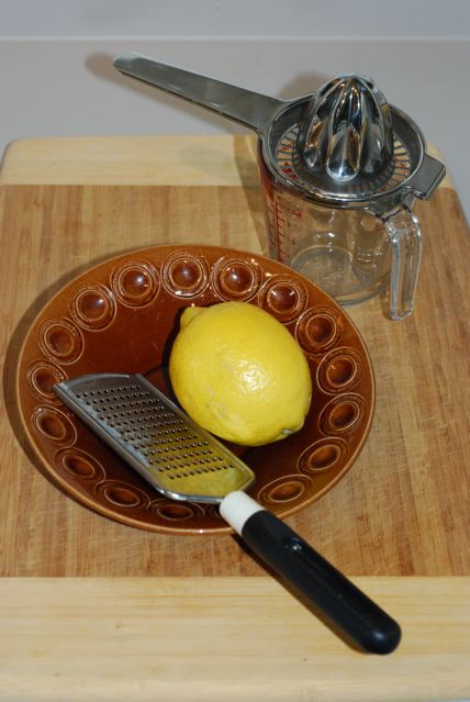 A whole lemon with zester, and juicer