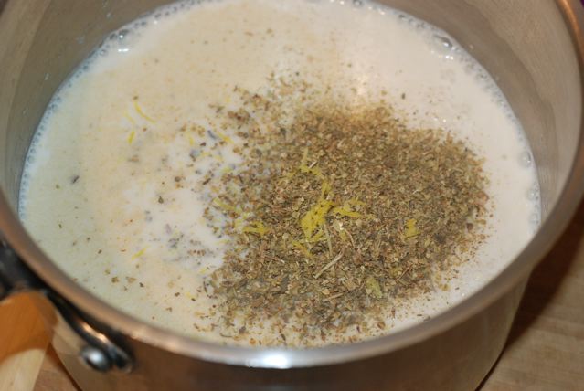 Adding herbs and lemon zest to the hot soy milk