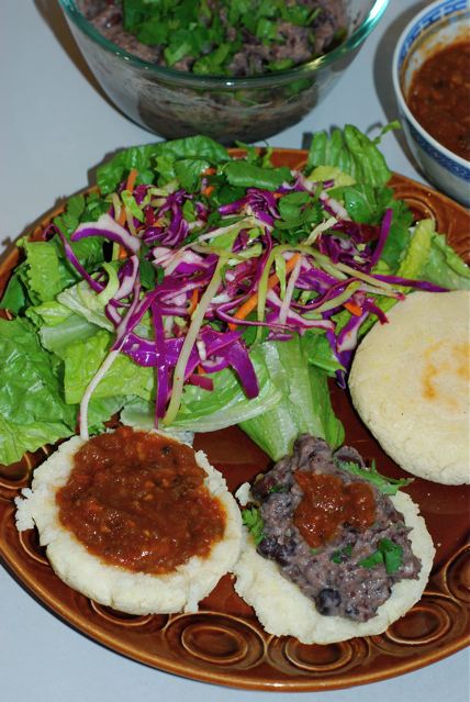 Finished salsa served on arepas with a side salad of slaw.