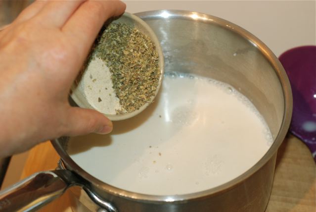 Add the herbs and garlic powder to the hot soy milk