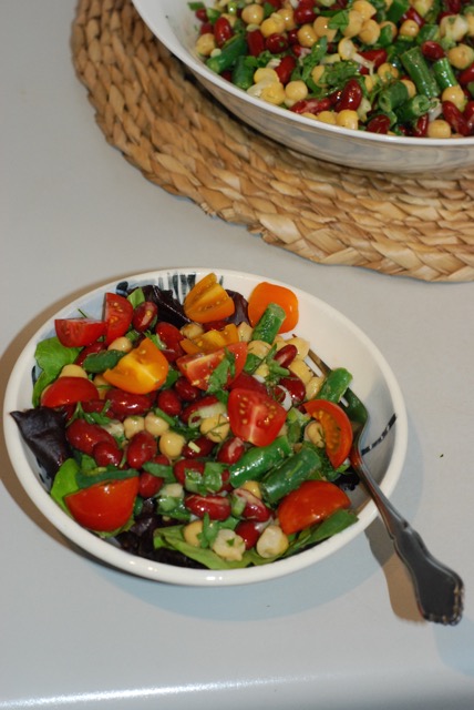Three Bean Salad served on a bed of mixed green with chopped cherry tomatoes. Yum!