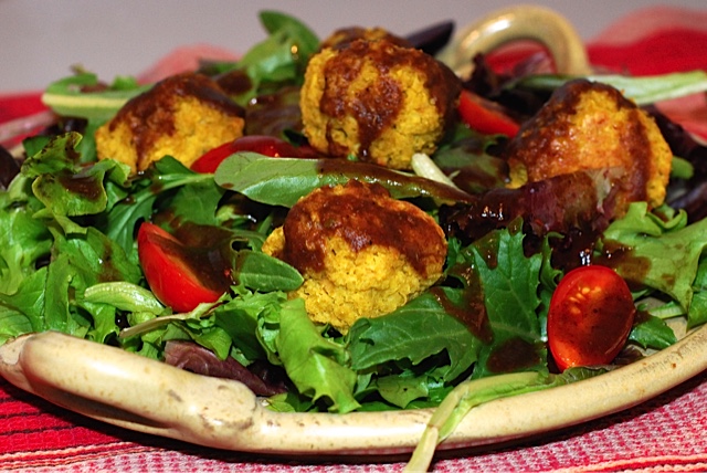 Curry Millet and Lentil Balls in a salad drizzled with tamarind Date Sauce