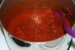 Add the can of whole tomatoes and mix well
