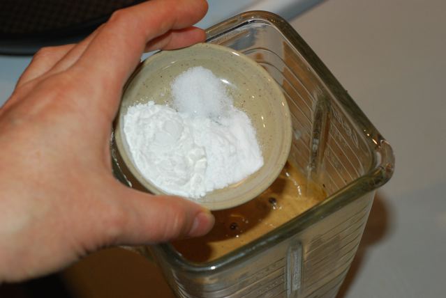 Adding the baking powder, baking soda and salt to the soaked grain in the blender jar