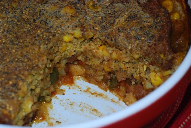 Sweet Potato Chili with Crusty Cornmeal Topping in the casserole dish with one serving removed