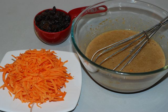 Wet ingredients with shredded sweet potato and raisins