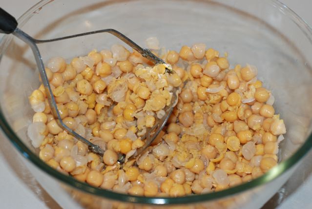 Mashing chickpeas in a bowl