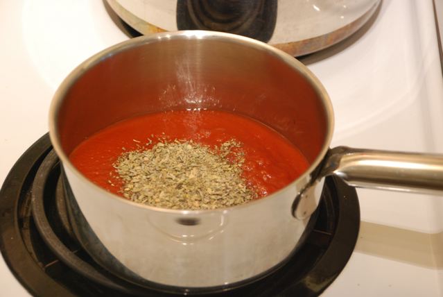 Tomato sauce with herbs in a pot