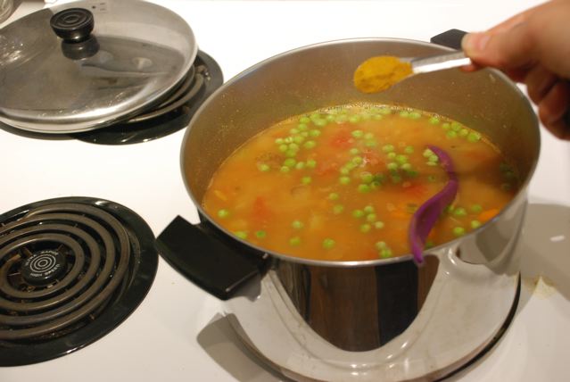 Stir in the frozen peas and garam masala
