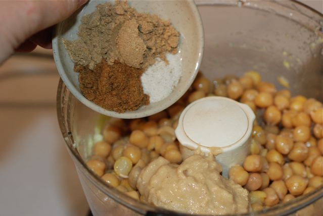 Add the chickpeas, salt, spices, tahini and a splash of water