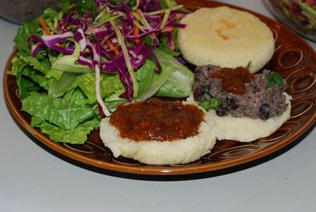 Smokey Roasted Tomato and Ancho Chili Salsa served on arepas with salad and beans
