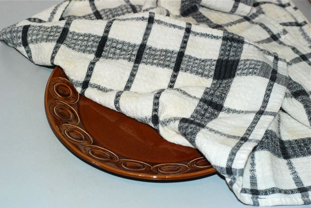 Plate covered in a folded kirchen towel